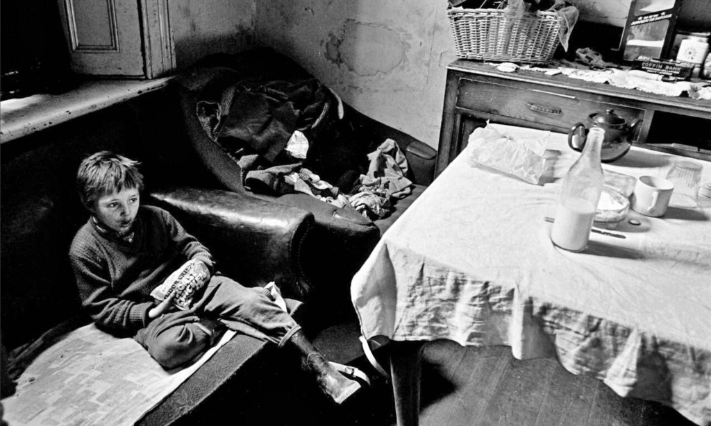 Newcastle slum, boy eating crisps