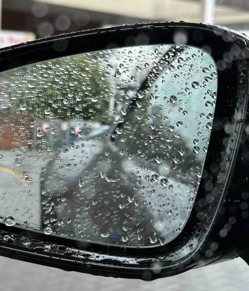 rain drops on the wing mirror of the car