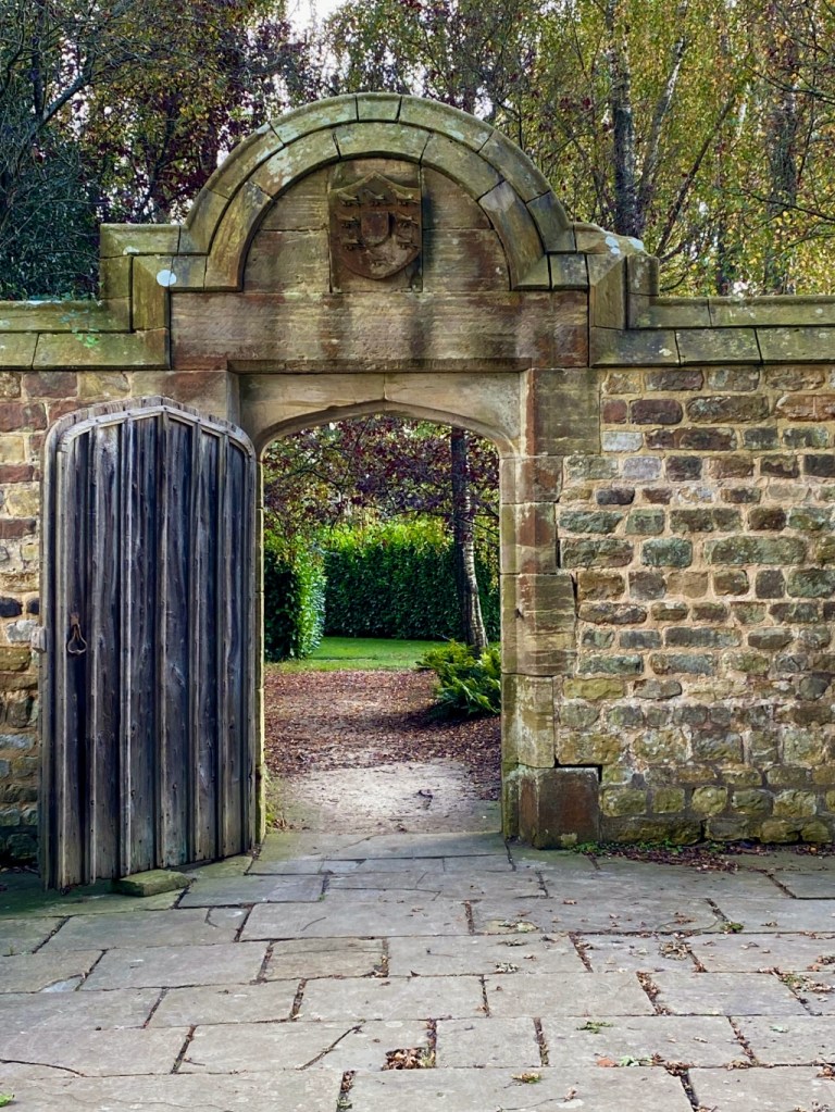 Stonewall garden gate with views toward trees