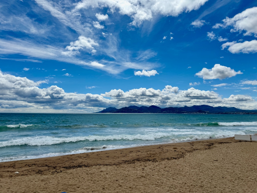 the beach at Cannes, France. Partly cloudy sky.