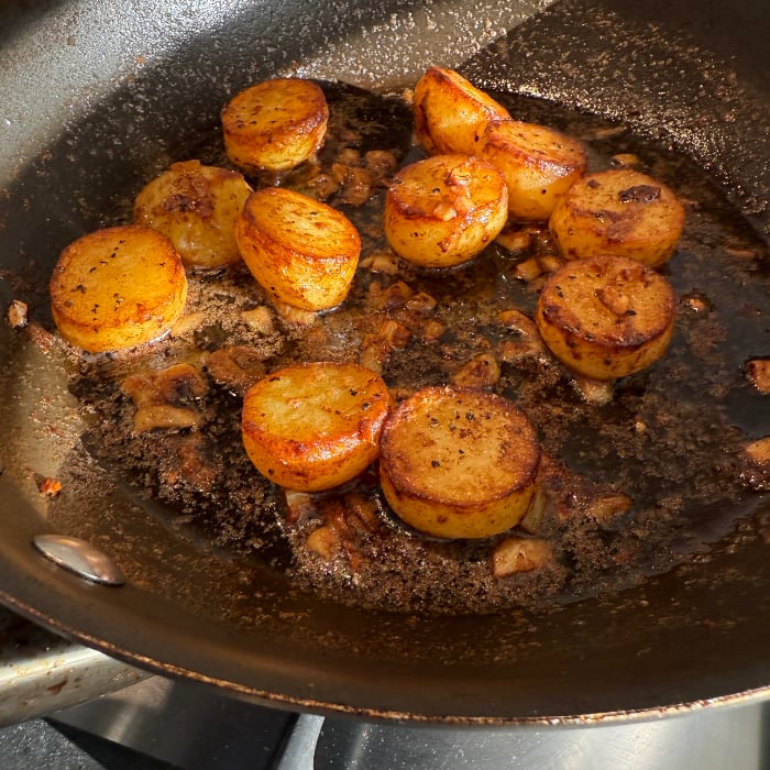 photo of fondant potatoes in a cast iron pan