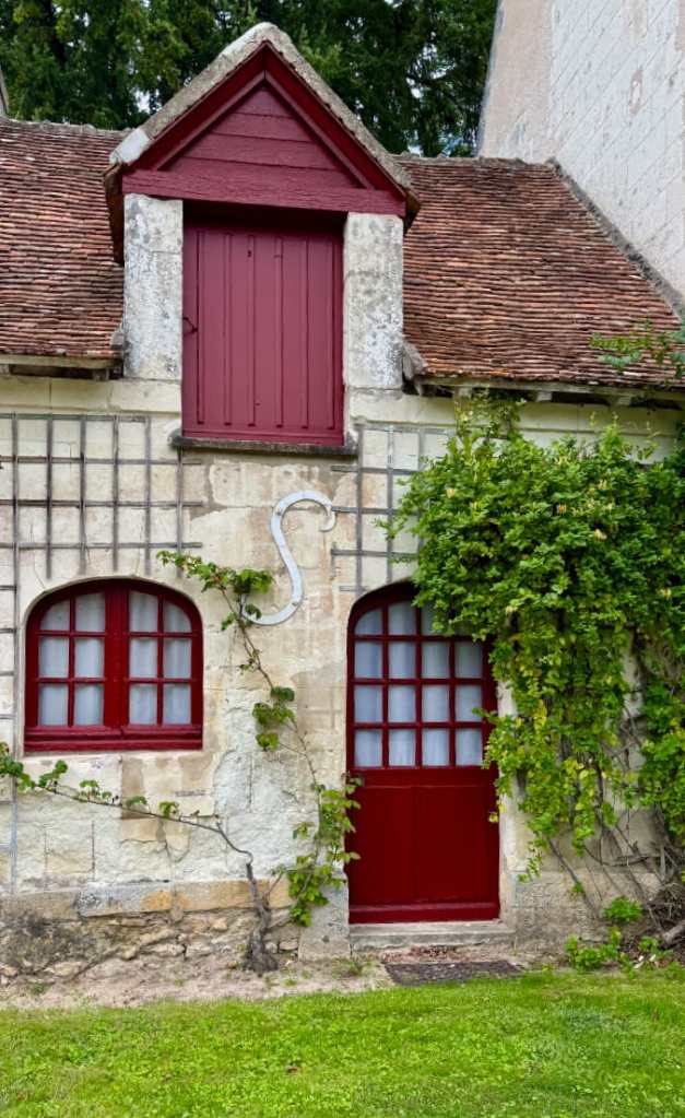 outbuildings at the Château de Chenonceau, Loure Valley, France. Red door with multi-paned windows.