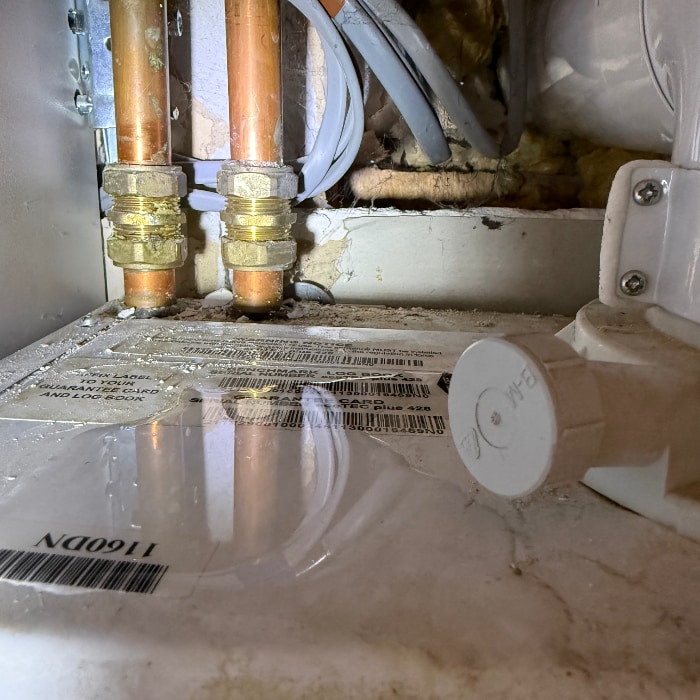 photo of the top of the boiler with a puddle of water