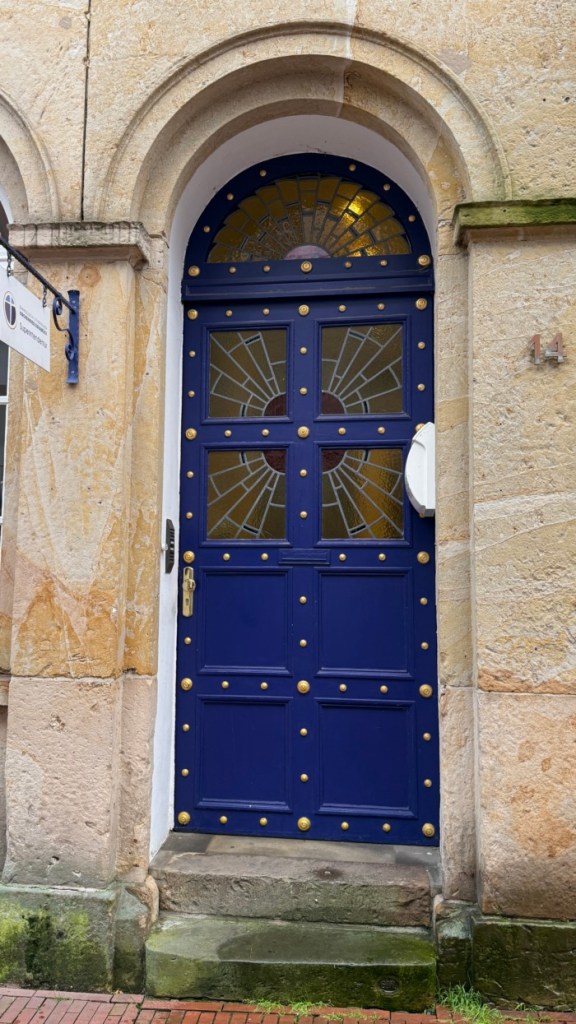 blue door with brass studs