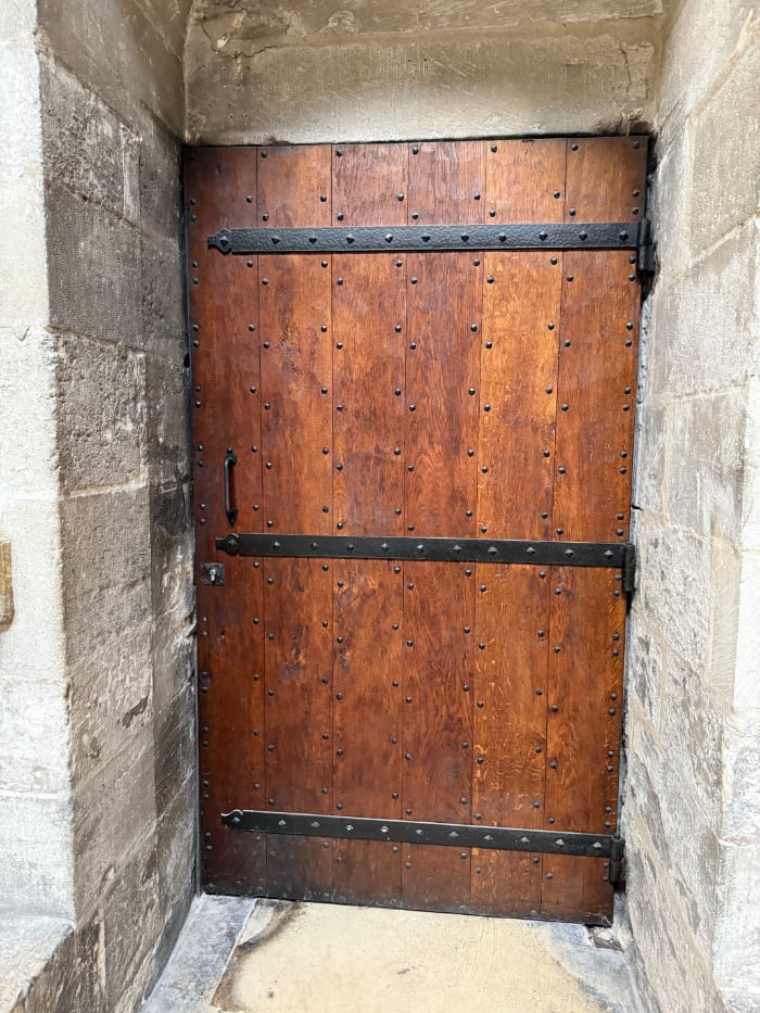 wooden door with iron braces and studs