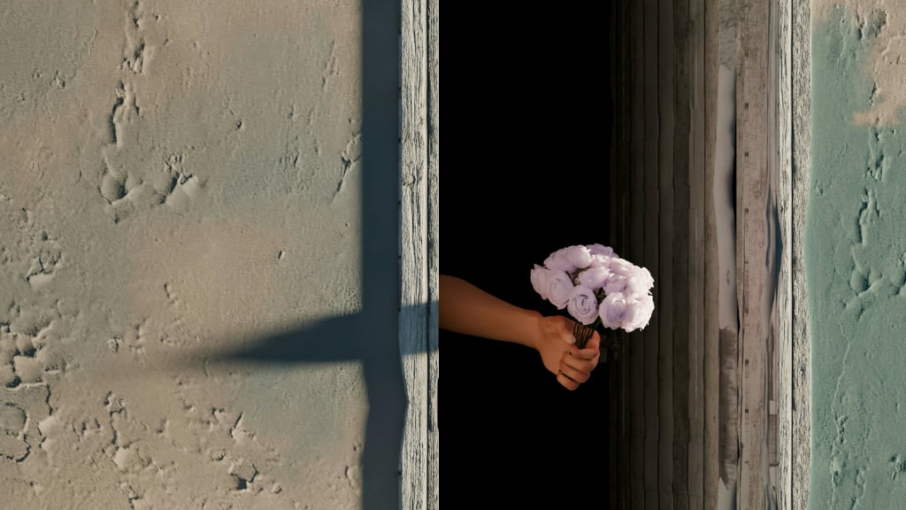 a posy of pink flowers in a hand extended through door